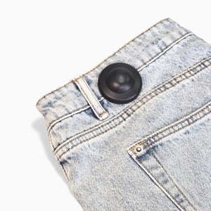 Detailed view of Mitag 50 anti-theft hard tags with durable casing and integrated pin for clothing protection.