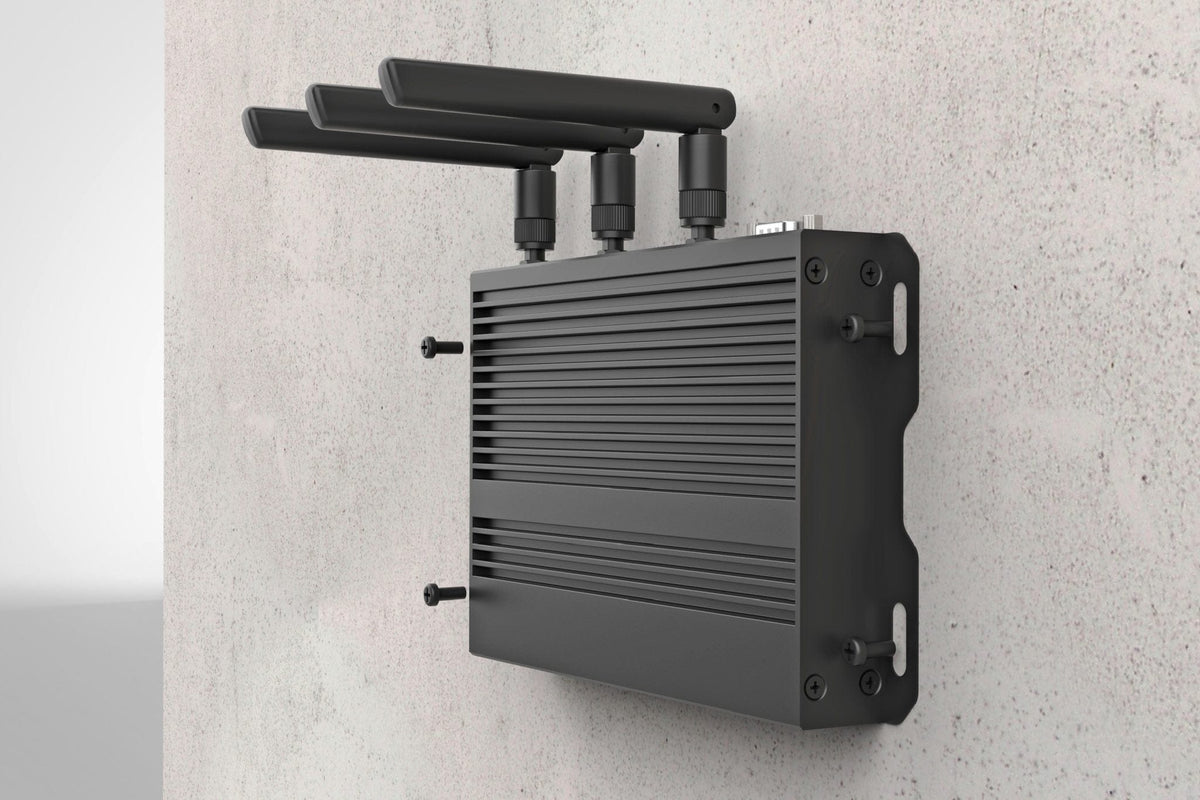 Black media player with antennas on a light gray wall