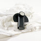 Forstag Round Clamp Tag securely attached to a bra strap without damaging the fabric.