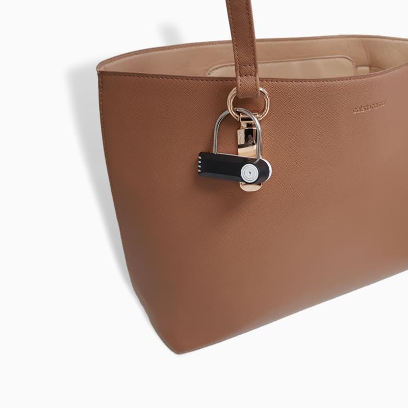 58 KHz Padlock Tag by Forstag on a handbag buckle
