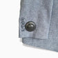 Side view of Mitag 50 anti-theft tag on clothing, showing low-profile yet tamper-resistant design.